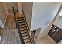 Upper level view of a staircase with dark wood railings at 722 Barrie Ct, Henderson, NV 89002