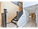 Interior view of a staircase with dark wood railings and light flooring at 722 Barrie Ct, Henderson, NV 89002