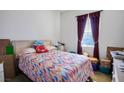 Bedroom with a double bed, window, and dark red curtains at 7436 Wagonwheel Ranch Way, Las Vegas, NV 89113