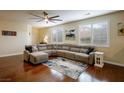 Spacious living room featuring hardwood floors, large sectional, and lots of natural light at 7611 Redcloud Peak St, Las Vegas, NV 89166