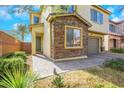 Two-story house with stone accents and a walkway at 7747 Harthill Park Ave, Las Vegas, NV 89113