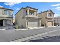 Two-story house with a tan exterior, attached garage, and balcony at 7868 Running Doe Ct, Las Vegas, NV 89149