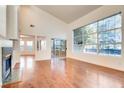 Spacious living room with hardwood floors, a fireplace, and large windows at 8600 Kiel Ridge Cir, Las Vegas, NV 89117