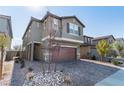 Two-story house with gray siding, brown garage door, and a tree in the front at 9217 Quartz Hills Ave, Las Vegas, NV 89178