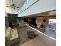 Spacious living room with high ceilings, L-shaped sofa, and hardwood floors at 936 Elon Ln, Indian Springs, NV 89018