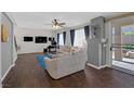 Living room with hardwood floors, large windows, and a view of the backyard at 10636 Amblewood Way, Las Vegas, NV 89144