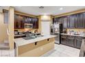 Spacious kitchen with dark cabinets, granite counters, and stainless steel appliances at 10636 Tulip Valley Rd, Las Vegas, NV 89179