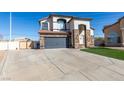 Two-story stucco home featuring a tile roof and a three-car garage at 1138 Gainesborough Ct, Henderson, NV 89015