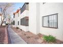 Apartment building exterior with brick-lined walkway, desert landscaping and security bars on windows at 1701 E Katie Ave # 65, Las Vegas, NV 89119