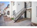 Building exterior featuring concrete staircase leading to the upper level and desert landscaping at 1701 E Katie Ave # 65, Las Vegas, NV 89119