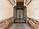 Close up of the front gate with custom ironwork and stone accents on either side of the entrance at 2026 Dakota Lodge Ave, Las Vegas, NV 89123