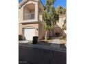 Inviting condo exterior featuring a private garage and manicured landscaping at 251 S Green Valley Pkwy # 1212, Henderson, NV 89012