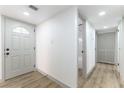 Renovated entryway with new flooring, a modern door, and access to the bathroom at 257 Colleen Dr, Las Vegas, NV 89107