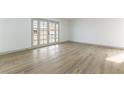 Bright living room with wood-look floors and French doors leading to a patio at 257 Colleen Dr, Las Vegas, NV 89107