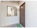 Inviting condo entry with a brown door and window at 2615 W Gary Ave # 1035, Las Vegas, NV 89123