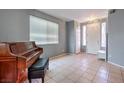 Bright entryway with tiled floor, piano, and neutral walls at 3241 Rainmaker St, Las Vegas, NV 89129