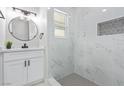 Modern bathroom featuring white marble-style tile and sleek fixtures at 601 Sierra Ln, Henderson, NV 89002