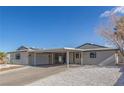 A single-story home featuring a covered carport, desert landscaping, and neutral color palette at 601 Sierra Ln, Henderson, NV 89002