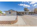 Single story home with carport, landscaped yard, and updated exterior at 601 Sierra Ln, Henderson, NV 89002