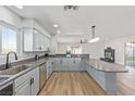 Open kitchen featuring stainless steel appliances, gray cabinets, and a spacious island at 601 Sierra Ln, Henderson, NV 89002