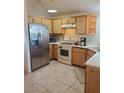 Galley kitchen with stainless steel appliances and wood cabinets at 6136 Evensail Dr, Las Vegas, NV 89156