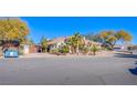 House with a three-car garage and gated driveway at 6185 N Conquistador St, Las Vegas, NV 89149