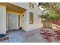 Tan house exterior with security door, small landscaping, and walkway at 7909 Dutch Canyon Ct, Las Vegas, NV 89131