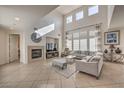 Spacious living room with a fireplace and large windows at 7923 Sleeping Lily Dr, Las Vegas, NV 89178