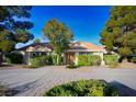 Charming single-story home with a well-manicured front yard and brick driveway at 8365 Hauck St, Las Vegas, NV 89139