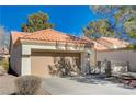 Single-story home with a tan garage door and Spanish tile roof at 9320 Quail Ridge Dr, Las Vegas, NV 89134