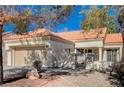 Single-story home with a tan garage door and Spanish tile roof at 9320 Quail Ridge Dr, Las Vegas, NV 89134