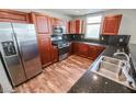 Modern kitchen featuring dark wood cabinets, granite countertops, and stainless steel appliances at 150 N Las Vegas Blvd # 804, Las Vegas, NV 89101