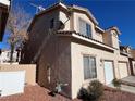 Rear view of two-story stucco home with attached garage at 16 Belle Essence Ave, Las Vegas, NV 89123