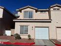 Front view of two-story stucco home with attached garage at 16 Belle Essence Ave, Las Vegas, NV 89123