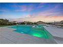 Modern pool and spa with light features at dusk at 1999 Oliver Springs St, Henderson, NV 89052