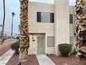 Two-story townhouse with palm trees and walkway at 2611 Aracatuba Ave, Las Vegas, NV 89121