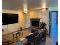 Living room with fireplace, large TV, and seating at 2611 Aracatuba Ave, Las Vegas, NV 89121