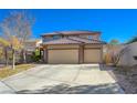Two-story house with three-car garage and landscaped yard at 3034 Scenic Valley Way, Henderson, NV 89052