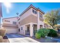 Two-story house with attached garage and desert landscaping at 5023 Tunnel Falls Dr, Las Vegas, NV 89141