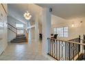 Grand foyer featuring tile flooring, a staircase, and elegant lighting at 5416 Lochmor Ave, Las Vegas, NV 89130
