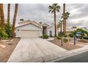 Inviting single-story home with desert landscaping and mature palm trees at 5416 Lochmor Ave, Las Vegas, NV 89130
