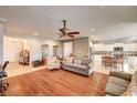 Open-concept living room with hardwood floors connecting to the kitchen and dining areas at 5615 Criollo Dr, Las Vegas, NV 89122