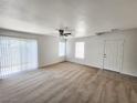Spacious living room with neutral carpeting and sliding glass door at 6104 Daisy Lee Ave, Las Vegas, NV 89108
