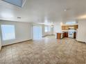 Open living room and kitchen with tile flooring at 6149 Ethel May Ave, Las Vegas, NV 89108