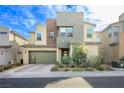 Contemporary home's exterior boasts a clean design and landscaped yard at 701 Emerson Creek Ct, North Las Vegas, NV 89084