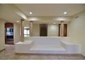 Spacious living room with built-in seating and a view of the kitchen at 7045 Edna Ave, Las Vegas, NV 89117