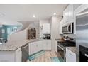 Modern kitchen with stainless steel appliances and granite countertops at 7455 Snowy Owl St # 102, North Las Vegas, NV 89084