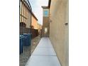 Side view of house with gated walkway and trash bins at 9217 Placer Bullion Ave, Las Vegas, NV 89178