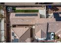 Aerial view of rooftops with solar panels, artificial turf and a well-maintained backyard at 1069 Appleblossom Time Ave, North Las Vegas, NV 89031