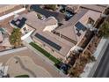 Aerial view of multiple homes featuring solar panels, landscaped yards and desert landscaping at 1069 Appleblossom Time Ave, North Las Vegas, NV 89031